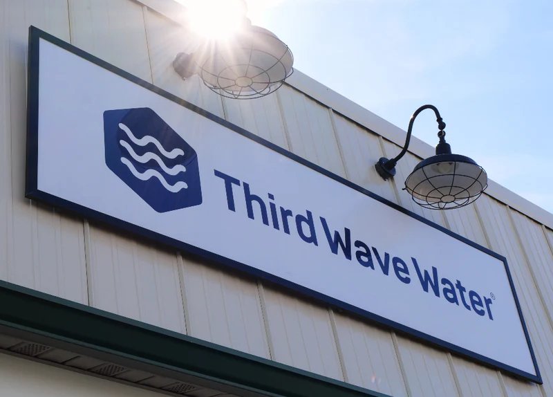 Third Wave Water sign on a building exterior with clear sky