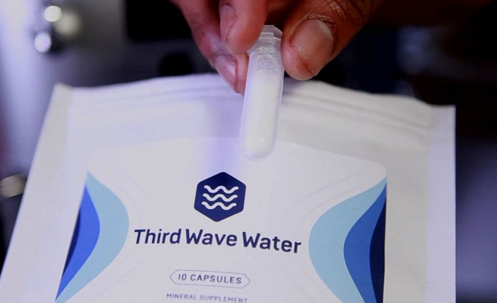 Third Wave Water supplement capsules being held above a package with the brand logo from NewsWatch
