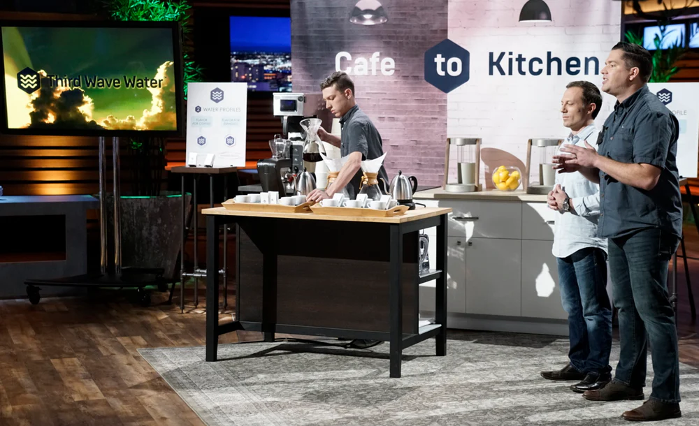 Behind the scenes photo of Charles and Taylor on television show stage